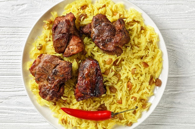 Roasted meat served with raisins saffron rice