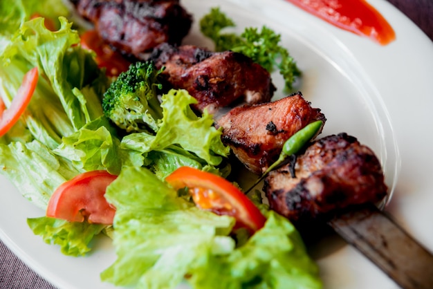 Roasted meat on the white plate.