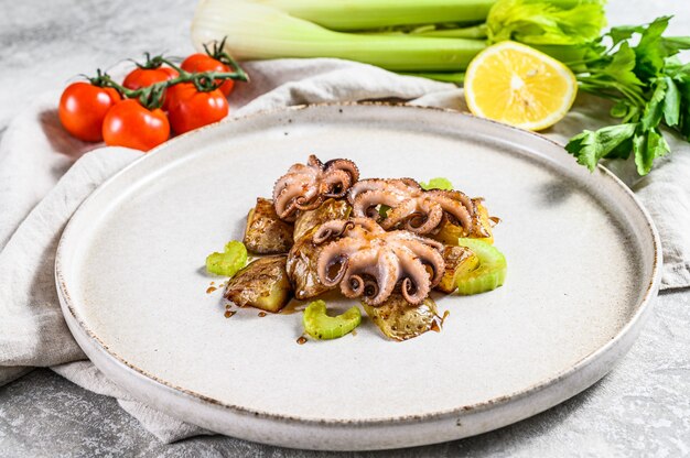 Roasted octopus with potatoes and celery.