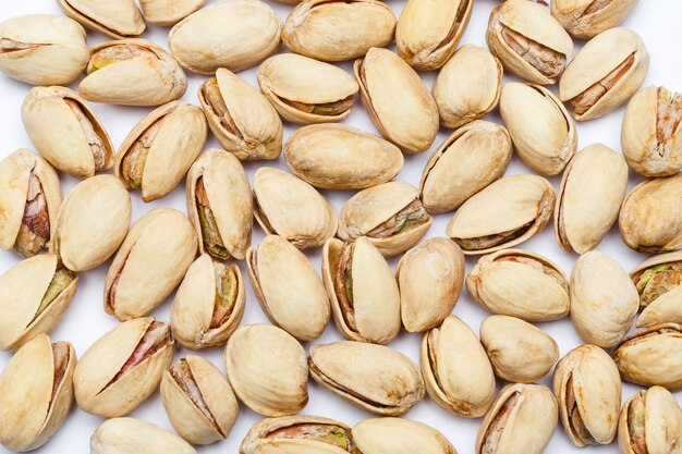 Roasted pistachios nuts on white table