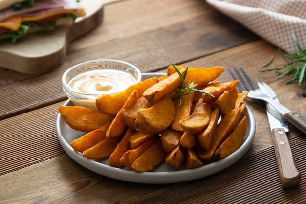 Roasted potato chips with sauce and herbs.