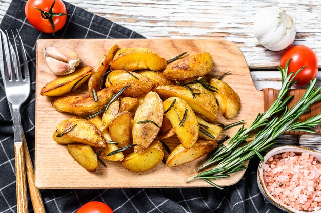 Roasted potato wedges with rosemary and salt. Tasty spicy potato 