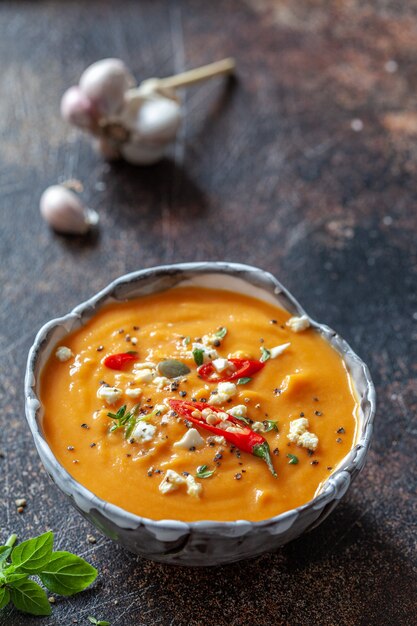 Roasted pumpkin and carrot soup with feta cheese and chili pepper