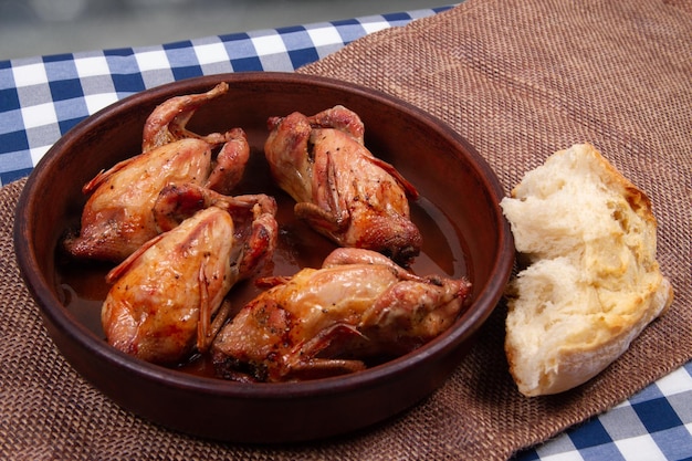 Roasted quail and Chunk of white bread Rustic style