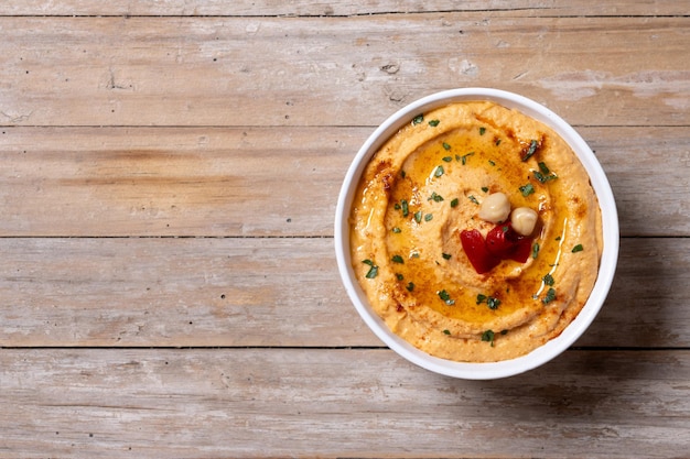 Roasted red pepper hummus on wooden table