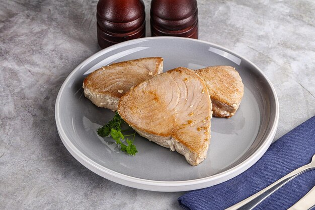 Roasted red tuna steak in the plate served parsley