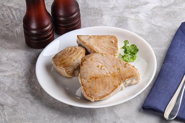 Roasted red tuna steak in the plate served parsley