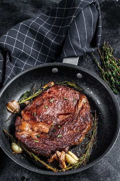 Roasted rib eye steak, ribeye beef meat in a pan