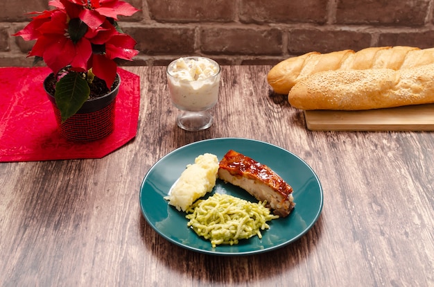 Roasted ribs marinated with barbecue sauce served with mashed potatoes spaghetti and bread