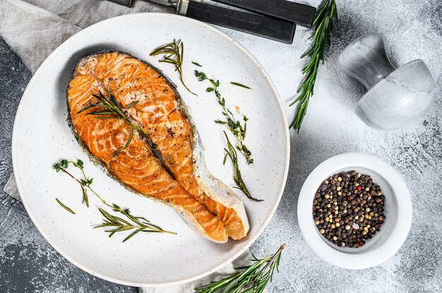 Roasted salmon steak. Healthy seafood. Gray wall. Top view