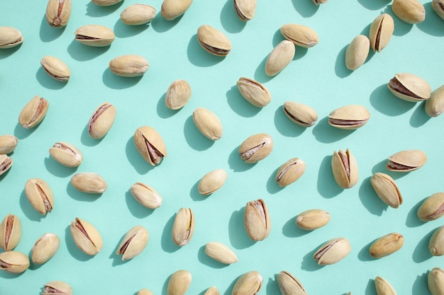 Roasted salted fresh pistachios on a bright colorful background