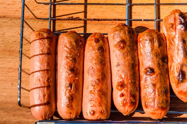 Roasted sausages on the rustic wooden table