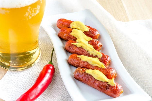 Roasted sausages with glass of beer