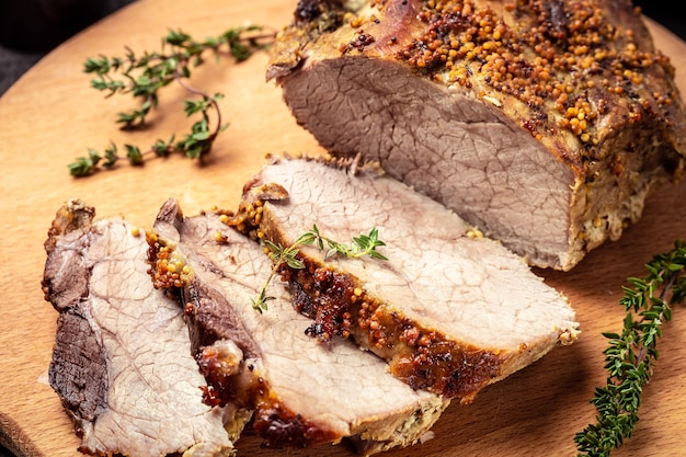 Roasted shoulder on a cutting board, Roasted Christmas ham of turkey. large piece of baked pork with mustard,