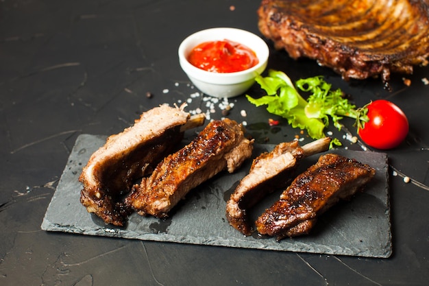 Roasted sliced barbecue pork ribs, focus on sliced meat