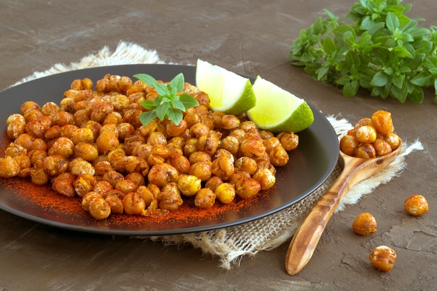 Photo roasted spicy chickpeas on a rustic background.