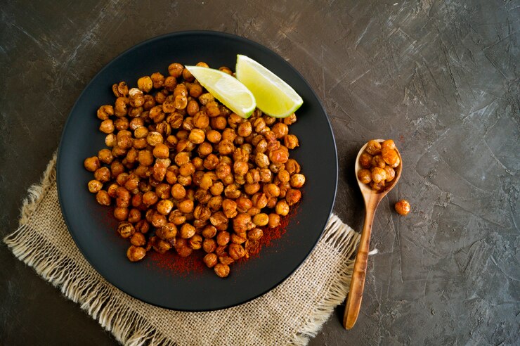 Roasted spicy chickpeas on a rustic background.