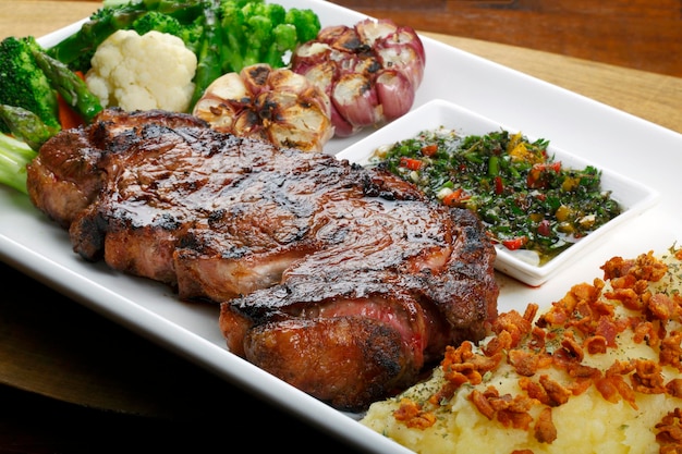 roasted steak with salad and potato