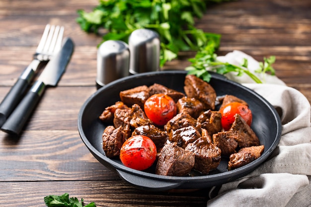 Roasted or stewed beef meat with tomato