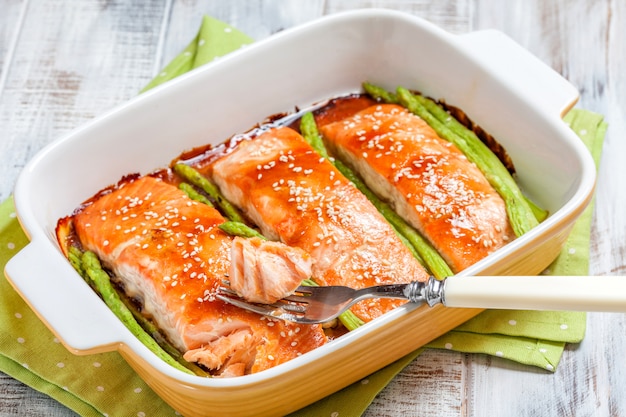 Roasted teriyaki salmon with asparagus in baking dish