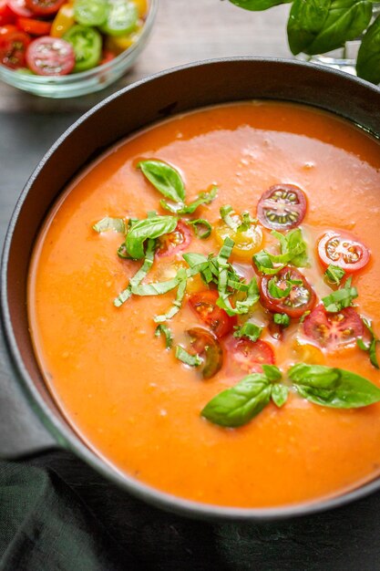 Roasted tomato soup in cast iron cooking pot.