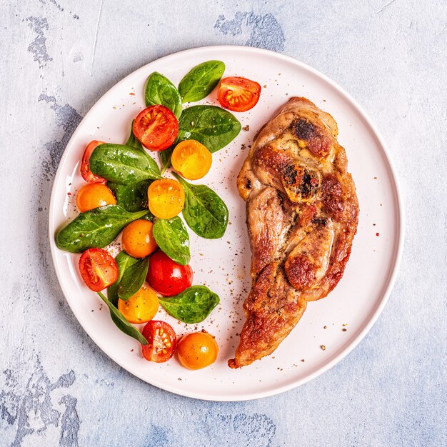 Roasted turkey steak with salad.