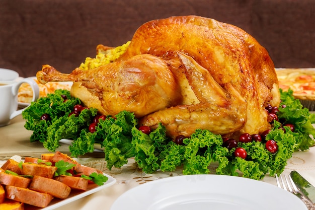 Roasted turkey with cranberries and yam on christmas or thanksgiving table.