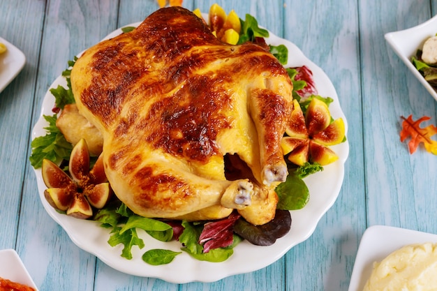 Roasted turkey with salad on table. Thanksgiving day. Close up.