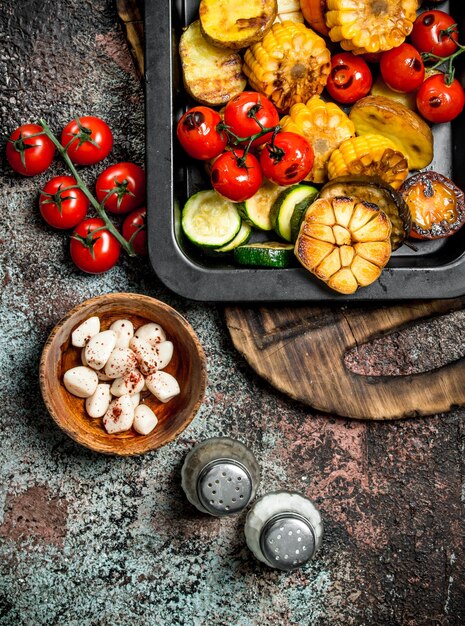 Roasted vegetables and mushrooms grilled in a pan