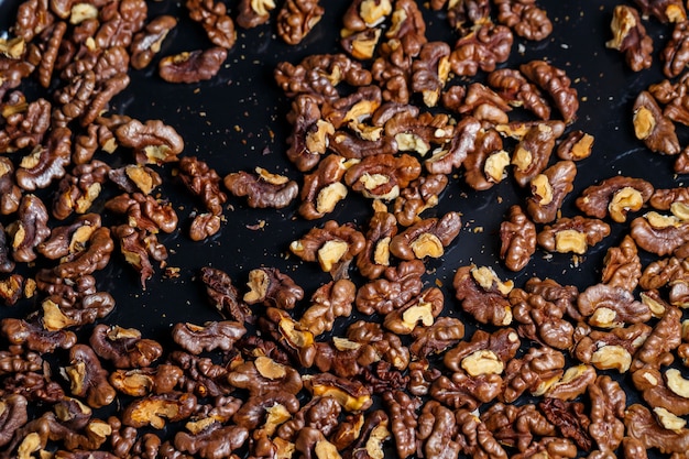 Roasted walnuts. Nuts help the brain work. Fatigue Food, Healthy Nuts. Superfood, vegan, vegetarian food concept. Macro of walnut texture, selective focus. Healthy snack