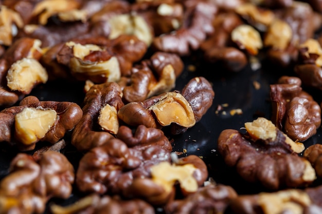 Roasted walnuts. Nuts help the brain work. Fatigue Food, Healthy Nuts. Superfood, vegan, vegetarian food concept. Macro of walnut texture, selective focus. Healthy snack