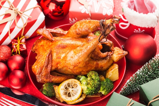 Roasted whole chicken with Christmas decoration.