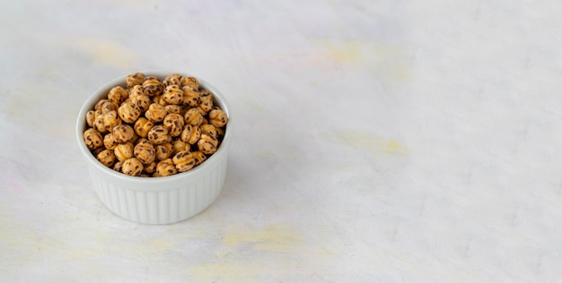 Roasted yellow chickpeas in wooden bowl Turkish name Leblebi