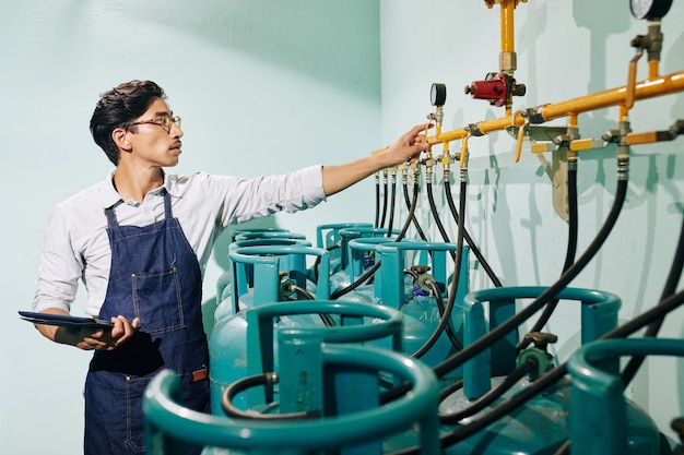 Roastery worker checking pressure