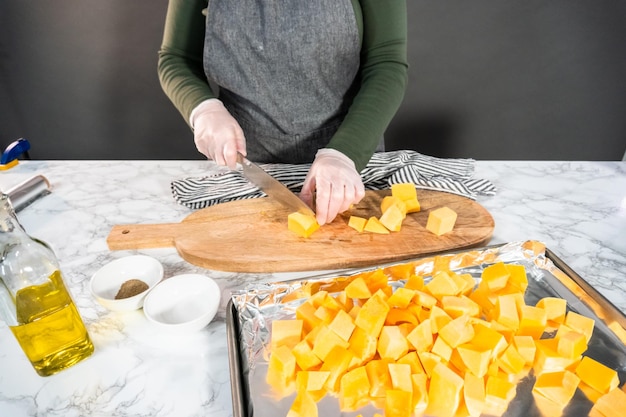 Roasting butternut squash with salt and pepper in olive oil.