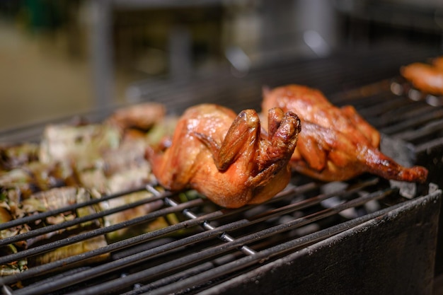 Roasting chicken on grille in night market