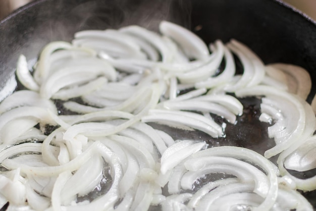 Roasting the chopped onion in a frying pan with butter