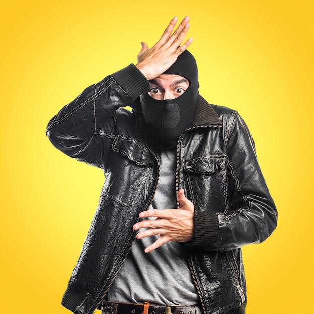 Robber having doubts on colorful background