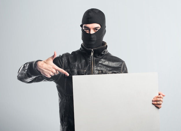 Robber holding an empty placard