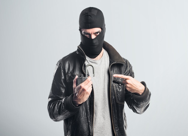 Robber holding vintage padlock