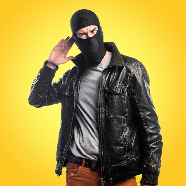 Robber listening something on colorful background