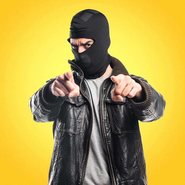 Robber pointing to the front on colorful background