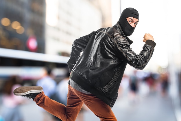 Robber running fast on unfocused background