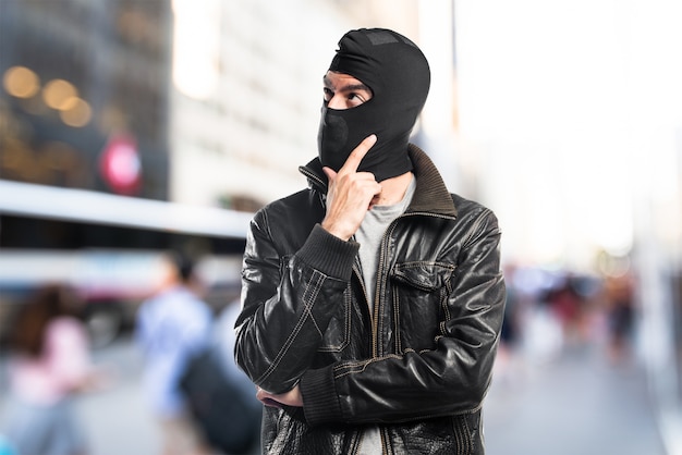 Robber thinking on unfocused background