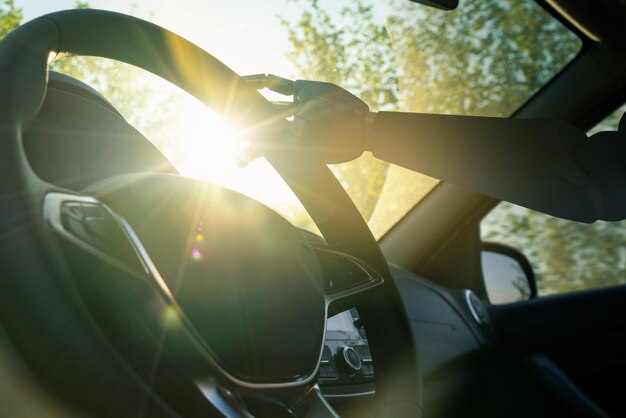 Robot arm on a steering wheel. Artificial intelligence drives a car. Autonomous vehicle concept.