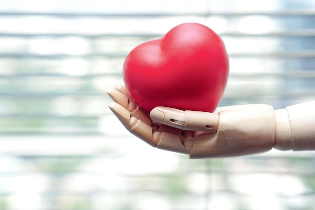 The robot hand is holding a red heart Medical Technology and future concept