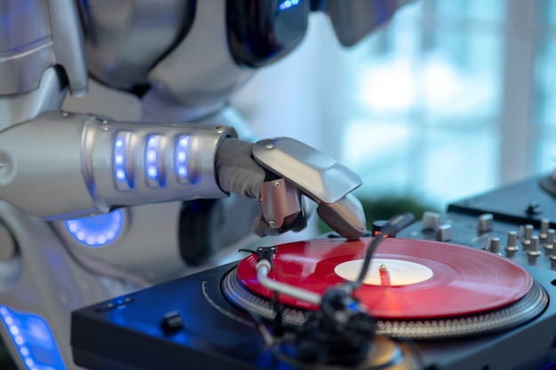 Robot listening to music standing next to the dj table