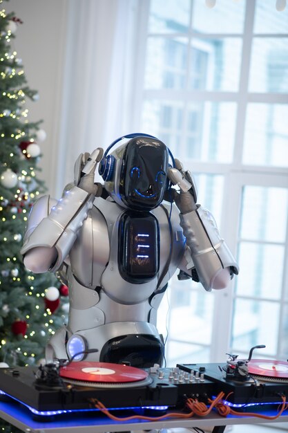 Robot listening to music standing next to the dj table