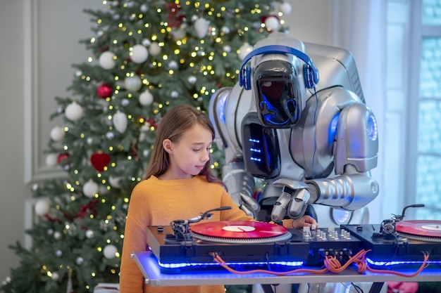 Robot listening to music standing next to the dj table