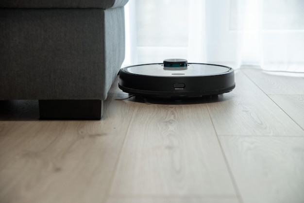 Robot vacuum cleaner is cleaning floor top view